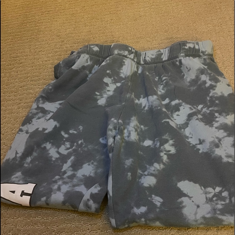 Blue tie dye sweat pants with NASA wording.